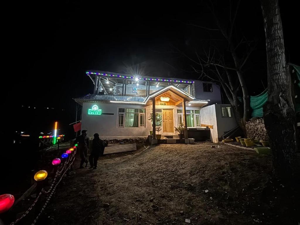 a house with lights on top of it at night at Keran resort in Keran