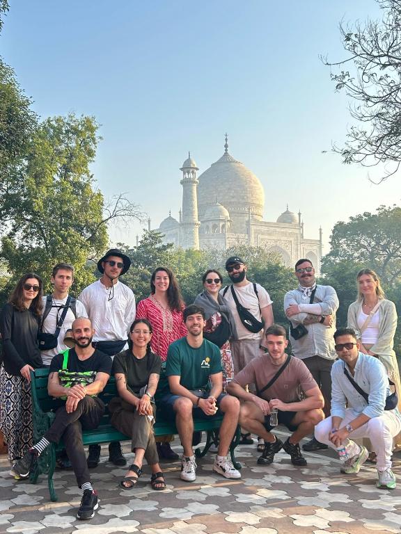 a group of people posing for a picture in front of a building at Zigzag Homestay in Agra