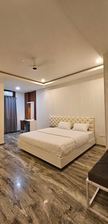 a bedroom with a large bed and a desk at Barkah inn in Kannur