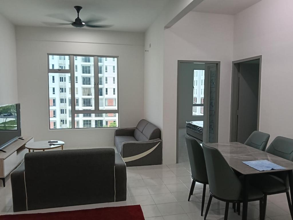 a living room with a table and chairs and a couch at D'Tarbiyyah Homestay in Labu