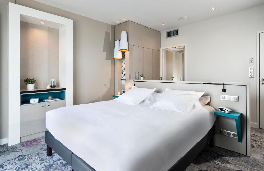 Postel nebo postele na pokoji v ubytování Hôtel Valdys Thalasso & Spa - la Baie