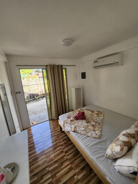 a bedroom with a bed and a sliding glass door at Little Zabina Inn in San Juan