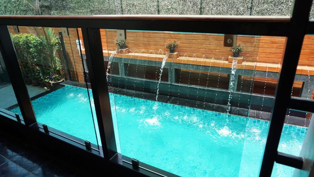 a view of a swimming pool through a window at Lanna Tree Boutique Hotel in Chiang Mai