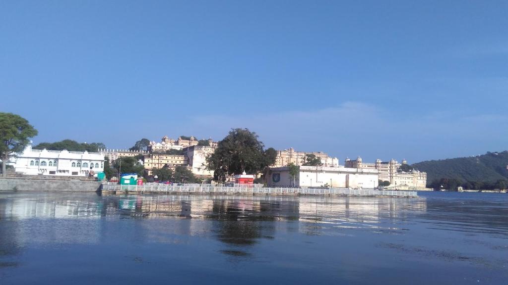 a large body of water with a city in the background at Lake face in Udaipur