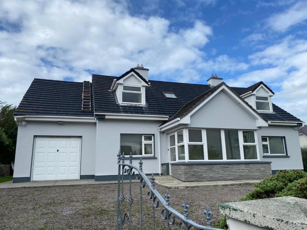 a white house with a black roof at The Willows in Kerry in Tralee
