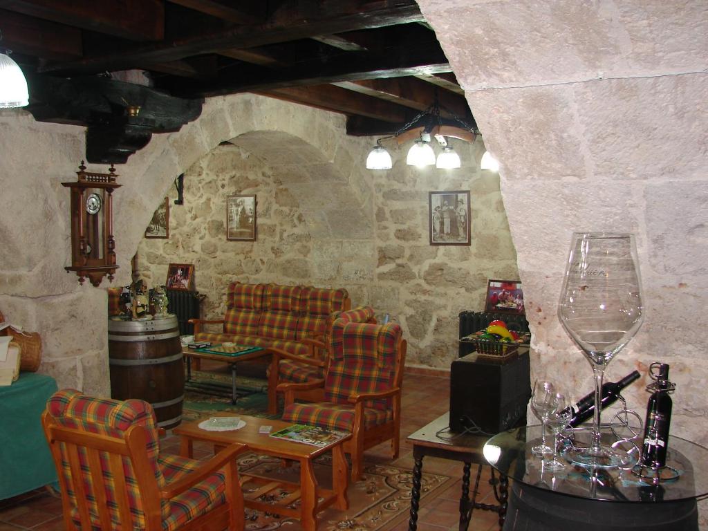 a living room with chairs and a table and a wine glass at La Hacienda de mi Señor in Lerma