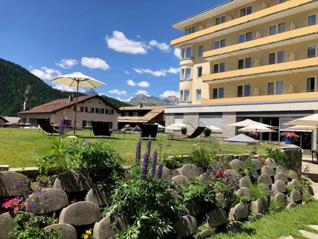 a building with a garden in front of a building at Hotel Schweizerhof Pontresina in Pontresina
