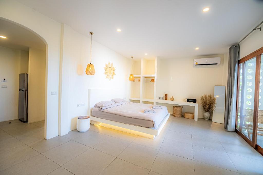 a bedroom with a bed in the middle of a room at Crocus Garden in Haad Yao