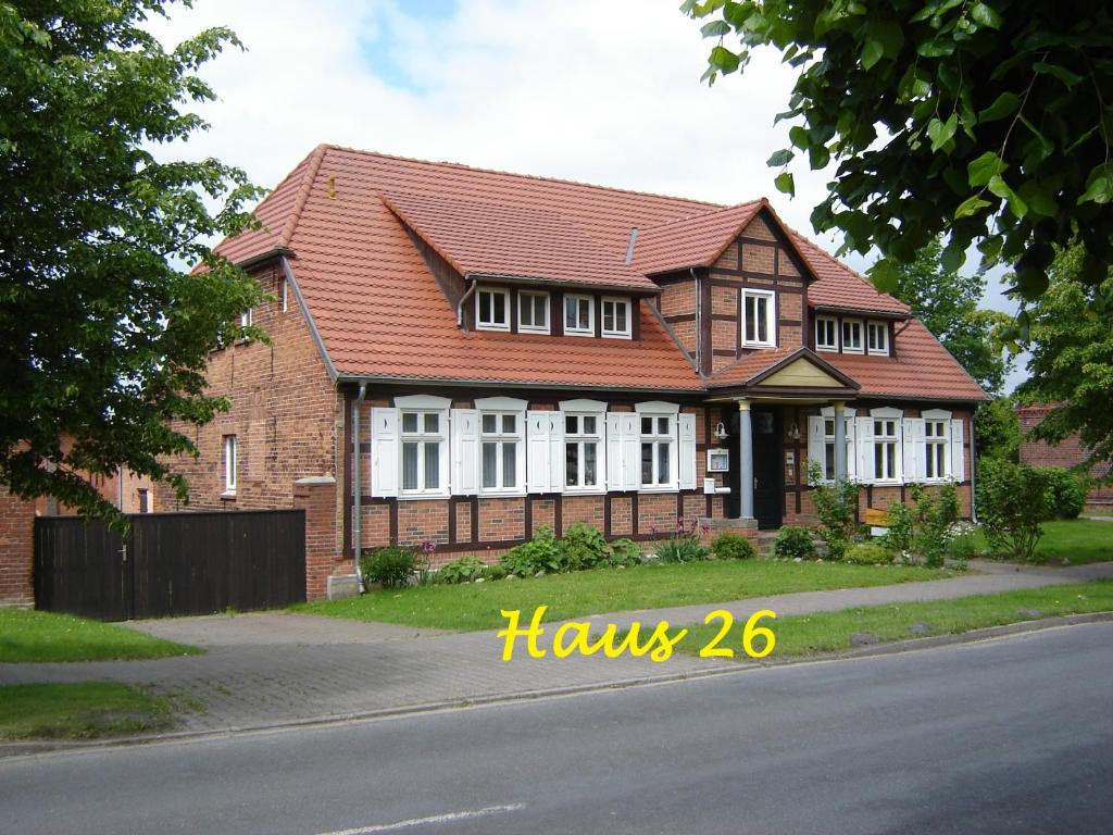 ein Backsteinhaus mit rotem Dach auf einer Straße in der Unterkunft Havelhof-Nitzow in Nitzow