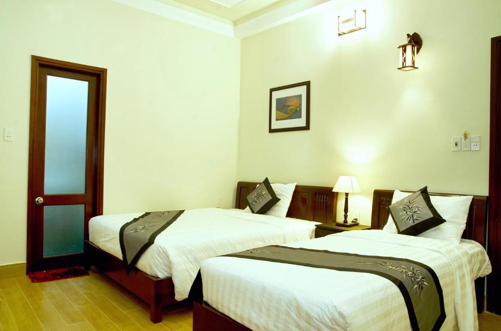 Postel nebo postele na pokoji v ubytování An Hoi Town Homestay