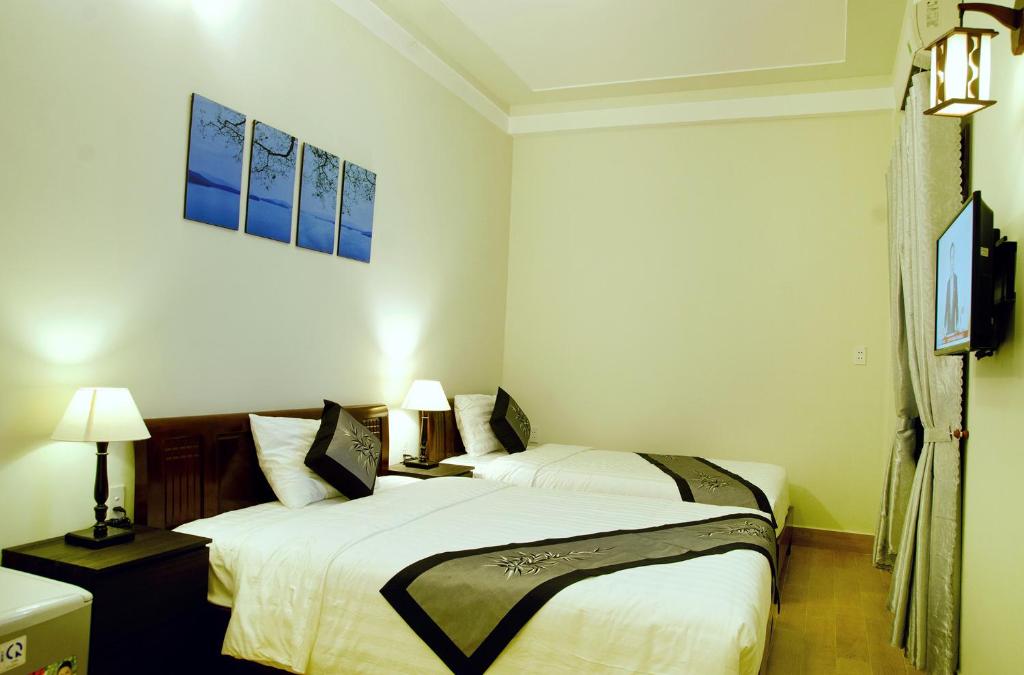 Postel nebo postele na pokoji v ubytování An Hoi Town Homestay