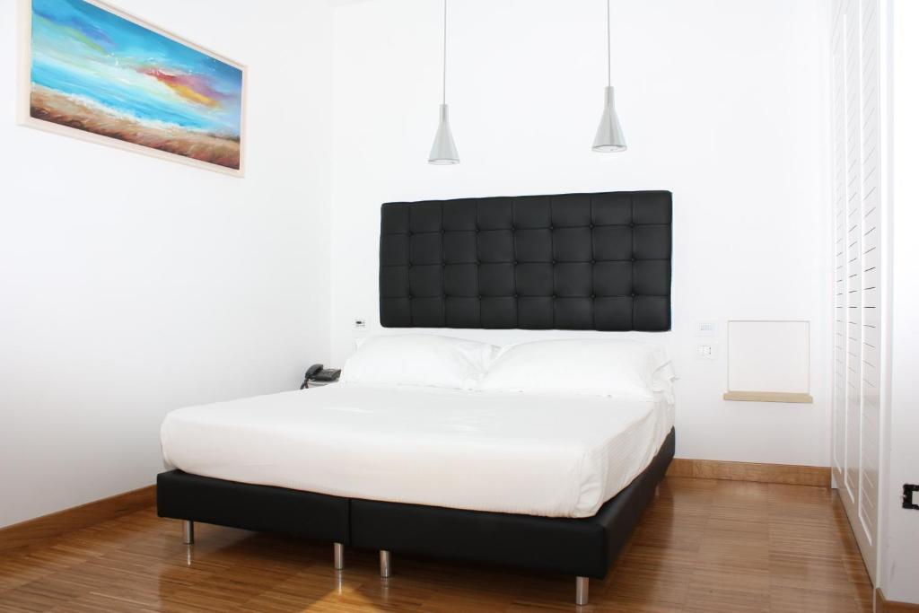 Postel nebo postele na pokoji v ubytování Hotel Del Conte
