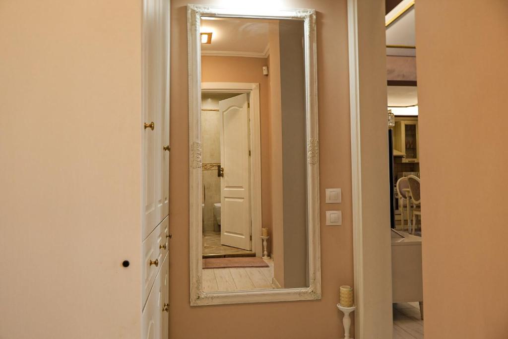 a mirror on the wall of a bathroom at Апартамент за гости Марица in Asenovgrad