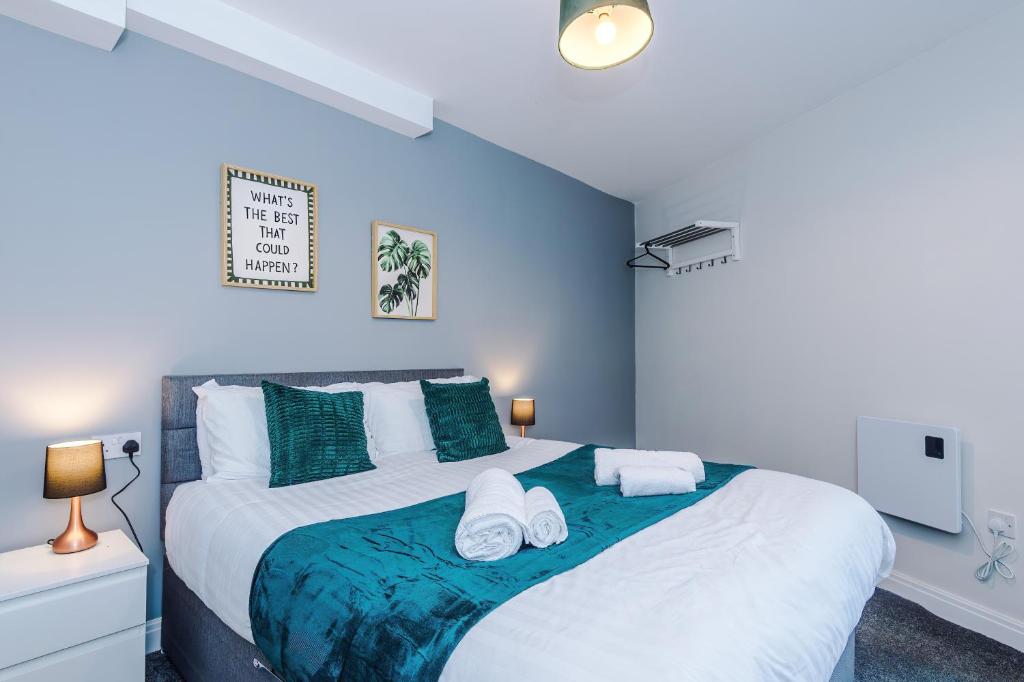 a bedroom with a large bed with towels on it at Spacious 6-Bedroom Central Blackpool in Blackpool