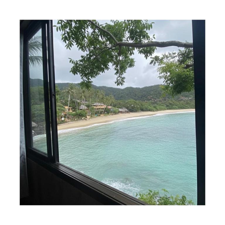 a view of a beach from a window at Family view A3 -Kantiang paradise resort- in Ko Lanta
