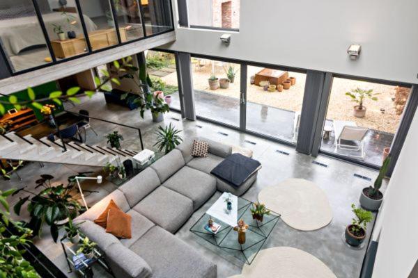an overhead view of a living room with a couch at Stylish Loft with Industrial Charm in Kortenberg