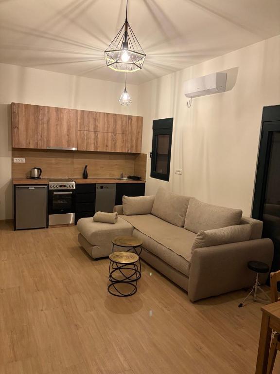 a living room with a couch and a kitchen at Holiday home Lavande in Tivat