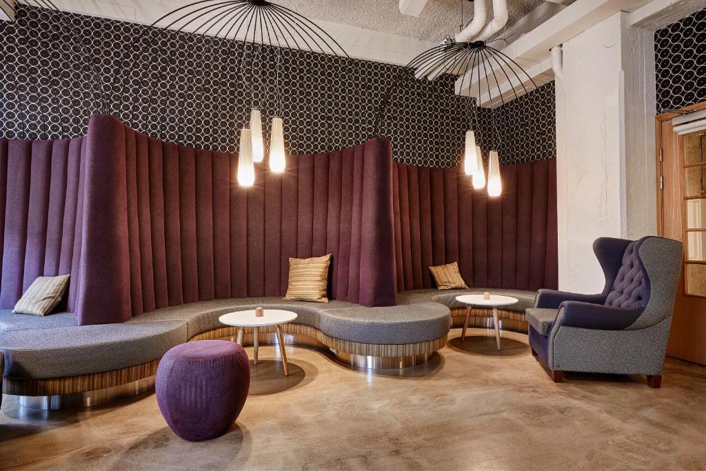 a room with purple curtains and tables and chairs at Reykjavik Marina - Berjaya Iceland Hotels in Reykjavík