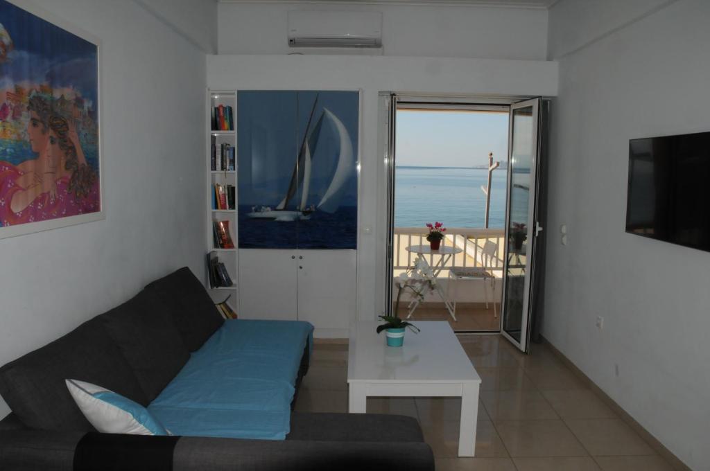 a living room with a couch and a table at Sunset by the sea 1 in Loutraki