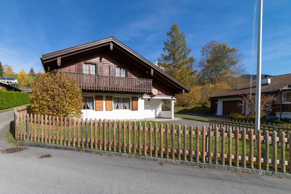 a wooden fence in front of a house at Sonnegge in Wildhaus