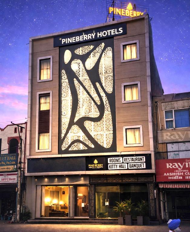 a building with a large sign on the side of it at Pineberry Hotels - Near Golden Temple in Amritsar