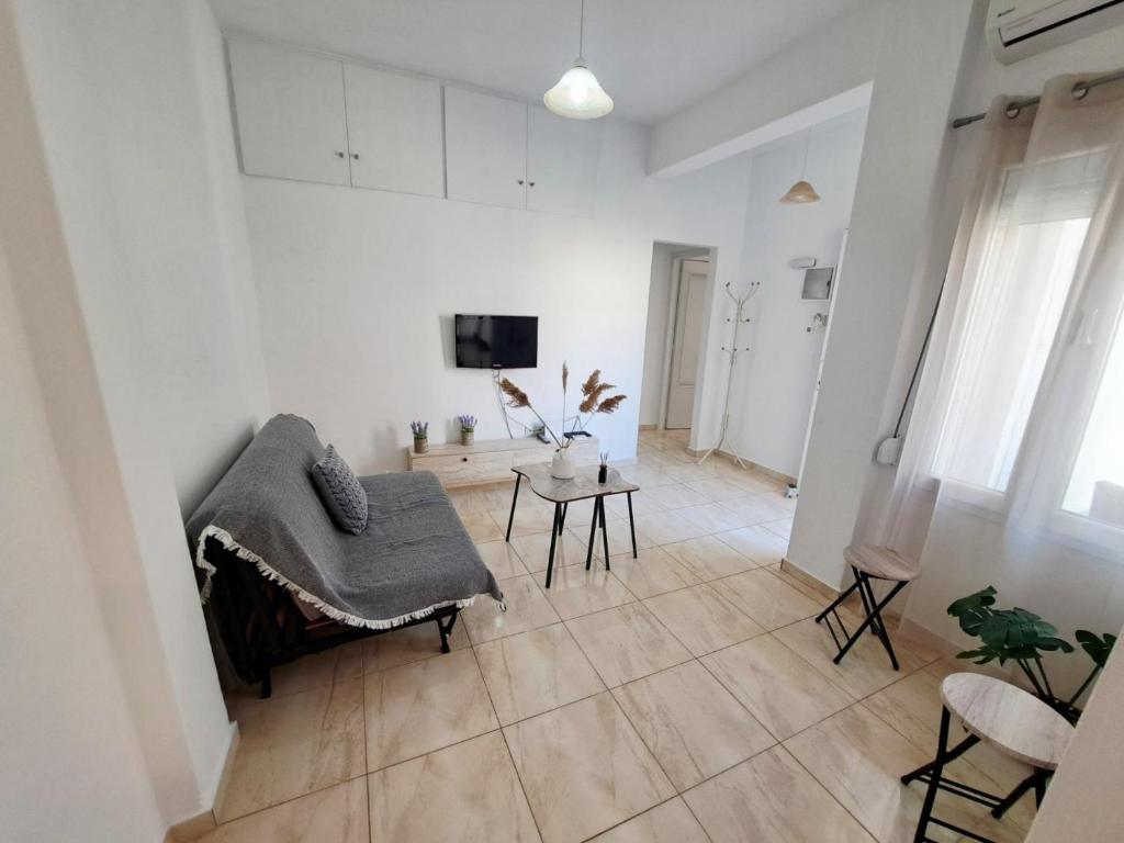 a living room with a couch and a table at City house in Myrina
