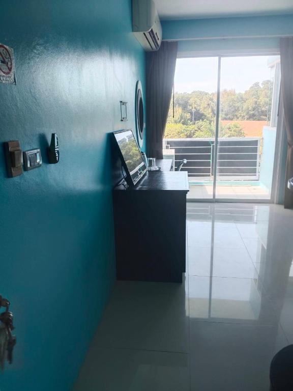 a blue kitchen with a laptop on a counter at Bedroom401 Kata Beach Phuket in Kata Beach