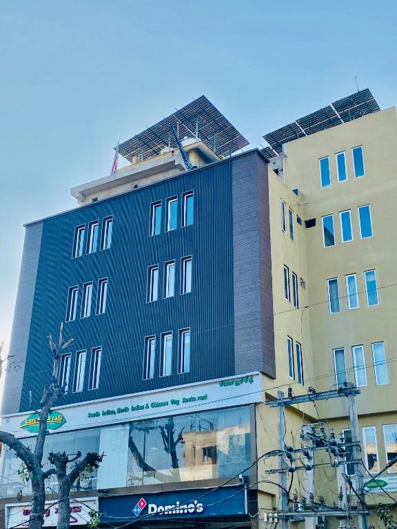 a tall building with solar panels on top of it at Hotel Ananta in Sasarām