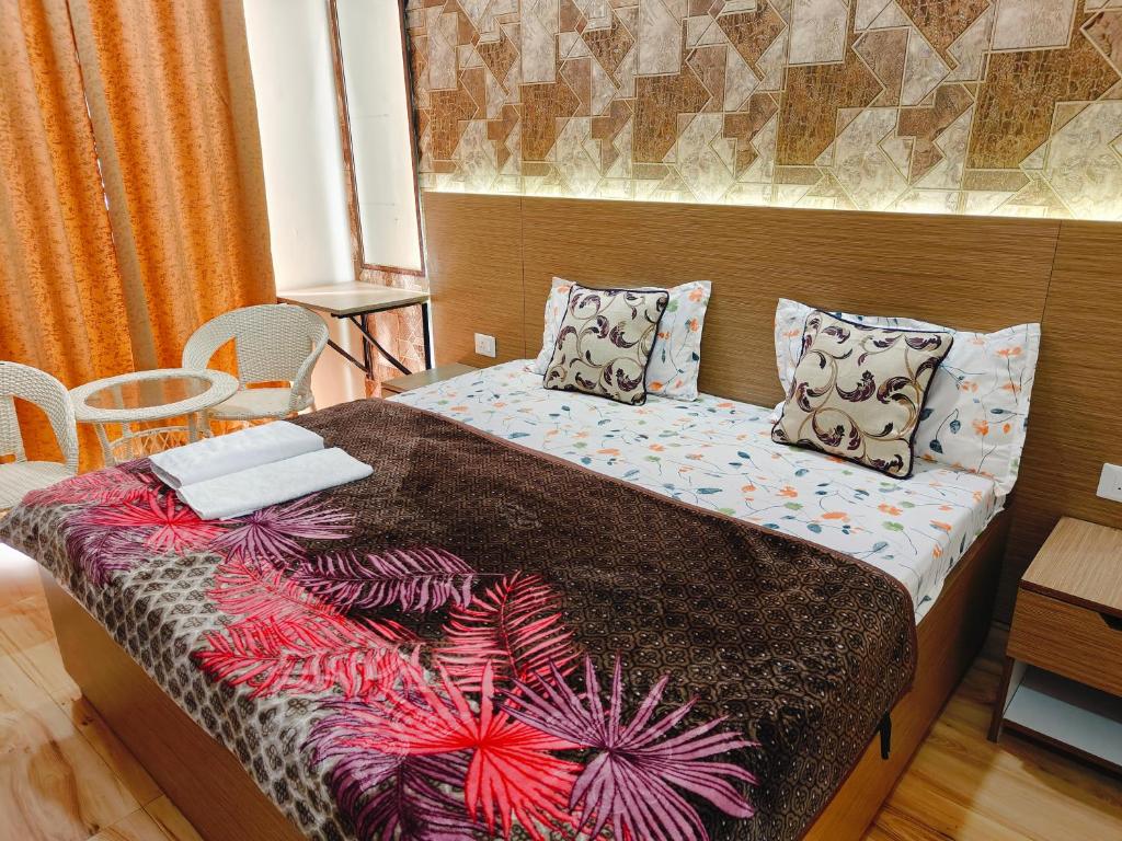 a small bedroom with a bed with at Kaveri splendid apartment in Greater Noida