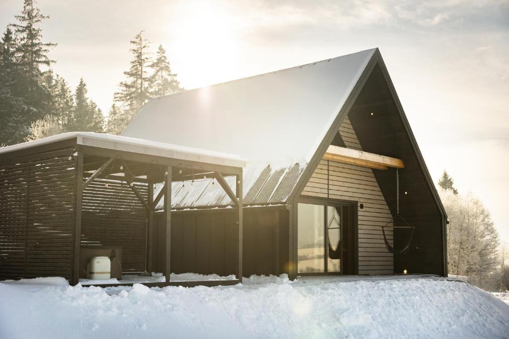 a house covered in snow in the snow at Barn&Haus-Stodoły Widokowe in Zubrzyca Dolna