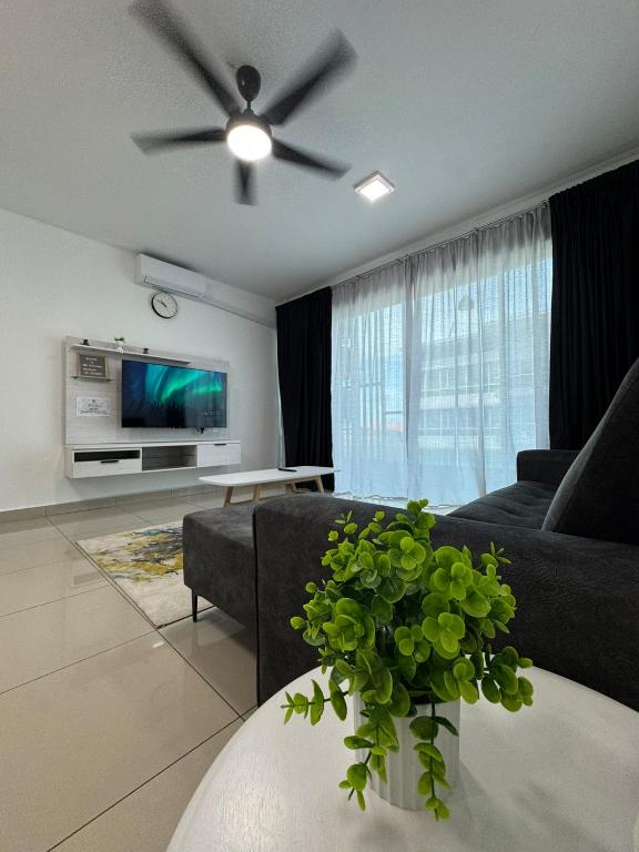 a living room with a couch and a ceiling fan at SDC Suite Home 4 in Lahad Datu