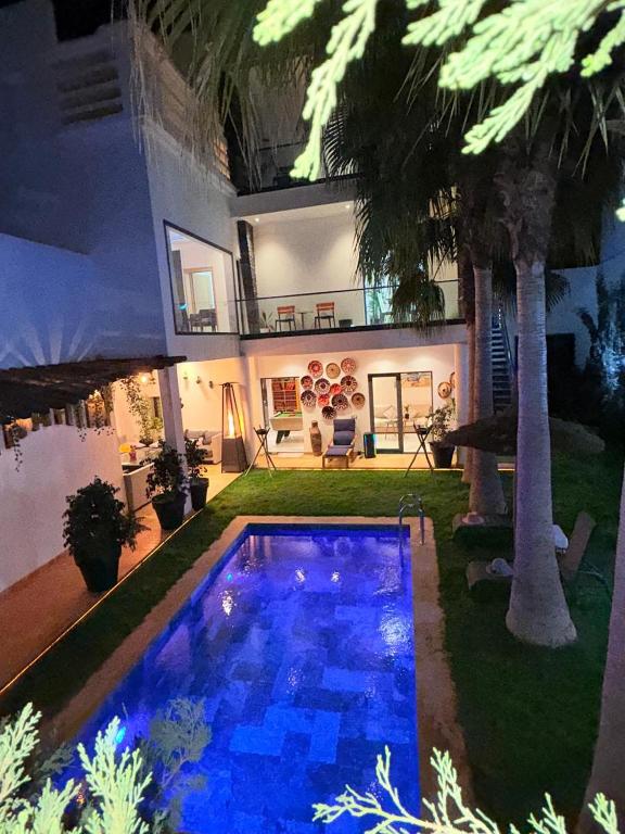 a house with a swimming pool in the yard at Oasis TIFNIT Villa with Pool View No vis A vis in Draïd