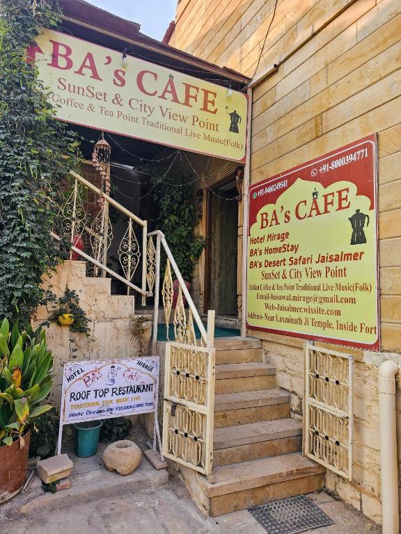 a building with a sign for a restaurant with stairs at Hotel Mirage in Jaisalmer