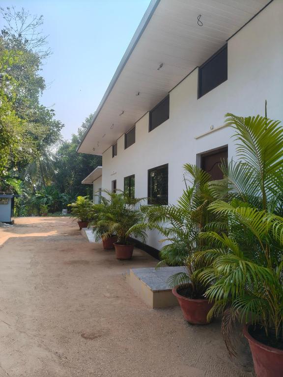 a building with potted plants in front of it at Lagoon lake view in Kollam