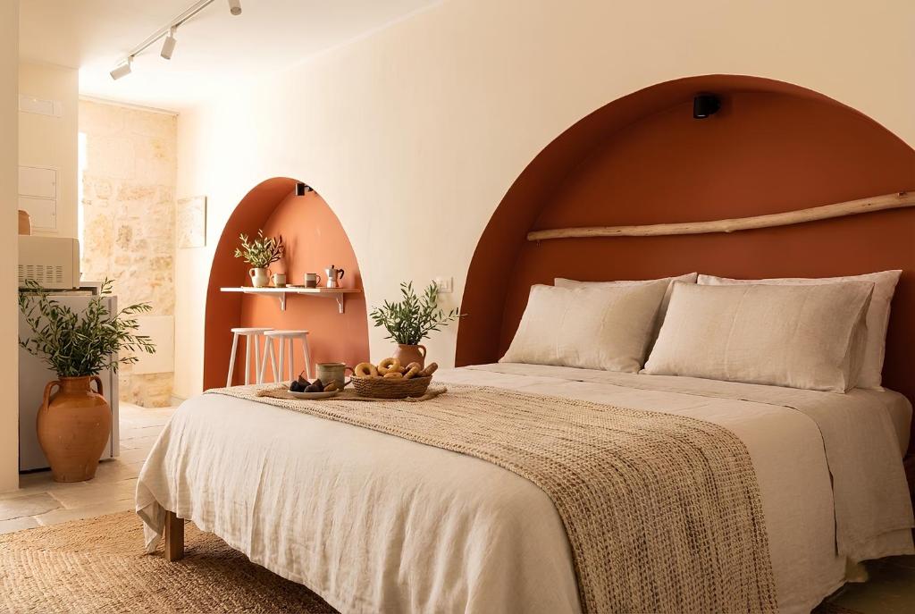 a bedroom with a large bed with a wooden headboard at Desideri di Puglia in Barletta