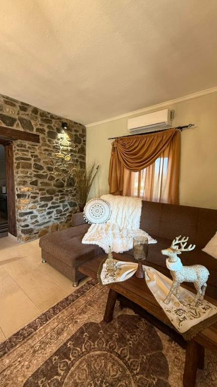 a living room with a couch and a table at Kerkini's Harmony House in Kerkini