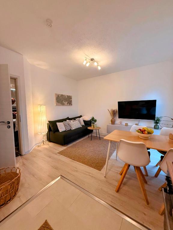 a living room with a table and a couch at Gemütliches Apartment in Kehl am Rhein