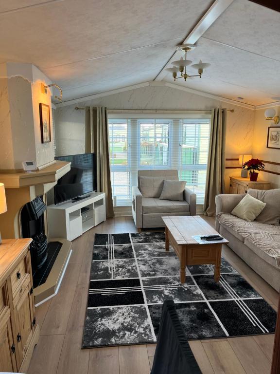 a living room with a couch and a table at West Cumbria static caravan in Workington