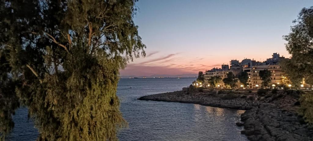 a view of a river at night with buildings at By the wave luxurious studios in Piraeus