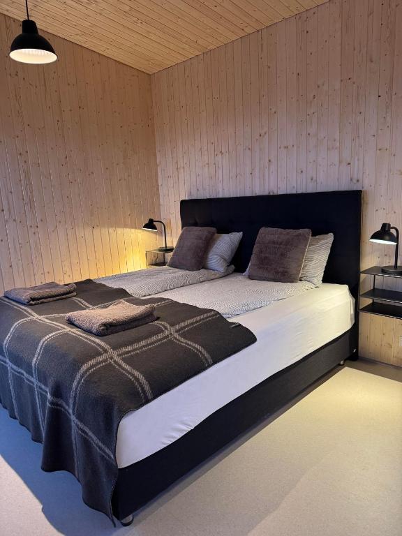 a bedroom with a large bed in a room at New listing - Krosshóll Cottage, built in 2026 in Hella