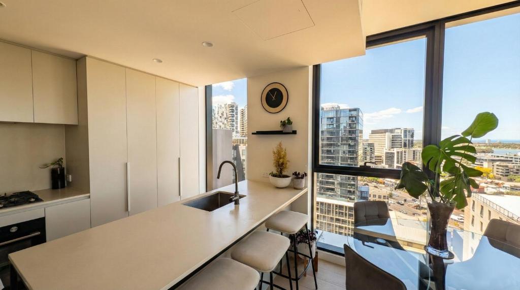 a kitchen with a counter and a large window at Domain House Executive in Melbourne