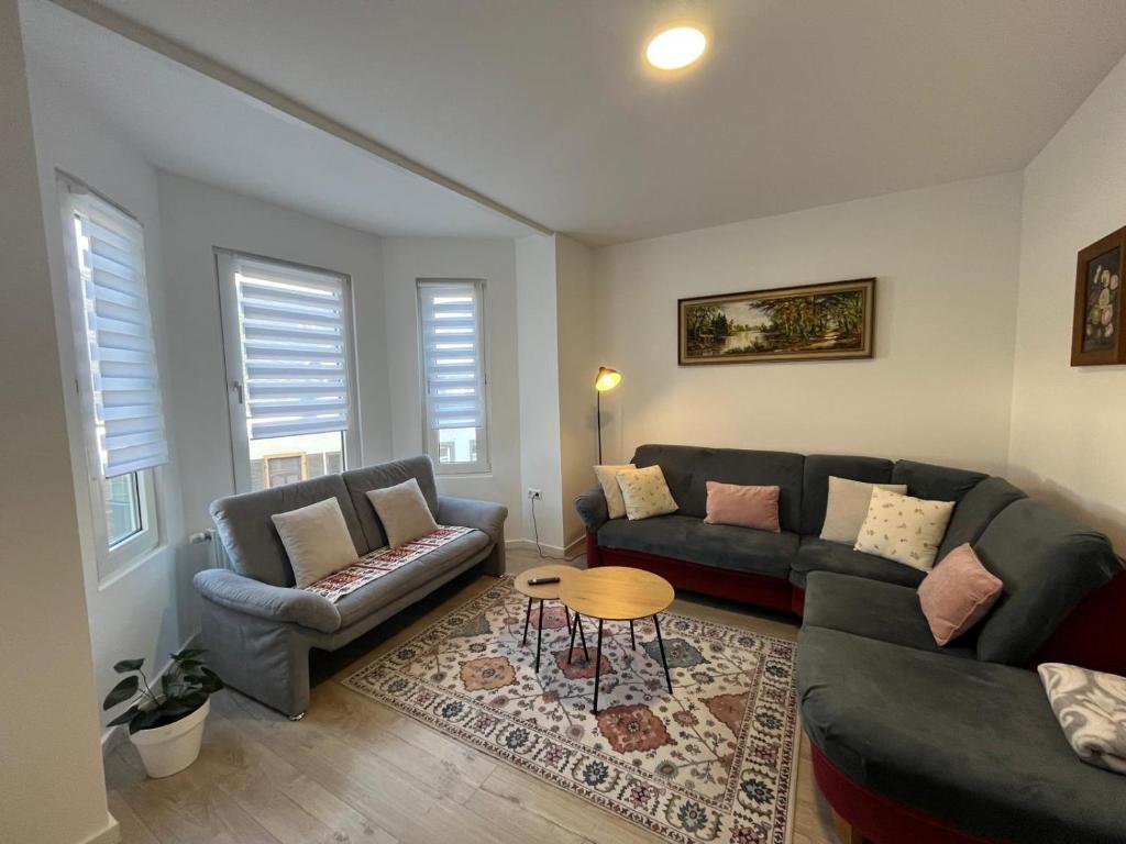 a living room with two couches and a table at Ferienwohnung Andi in Gerolstein
