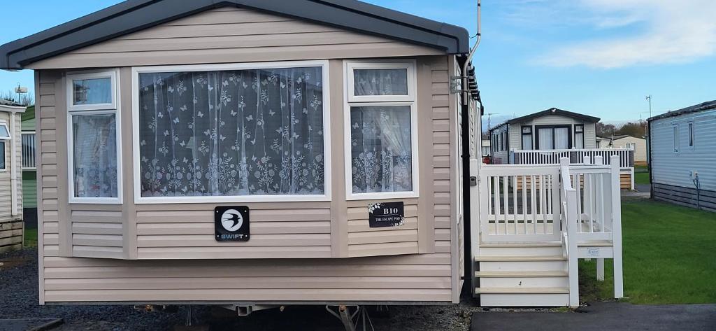 a small house with a door and a window at B10 - The Escape Pod in Heysham
