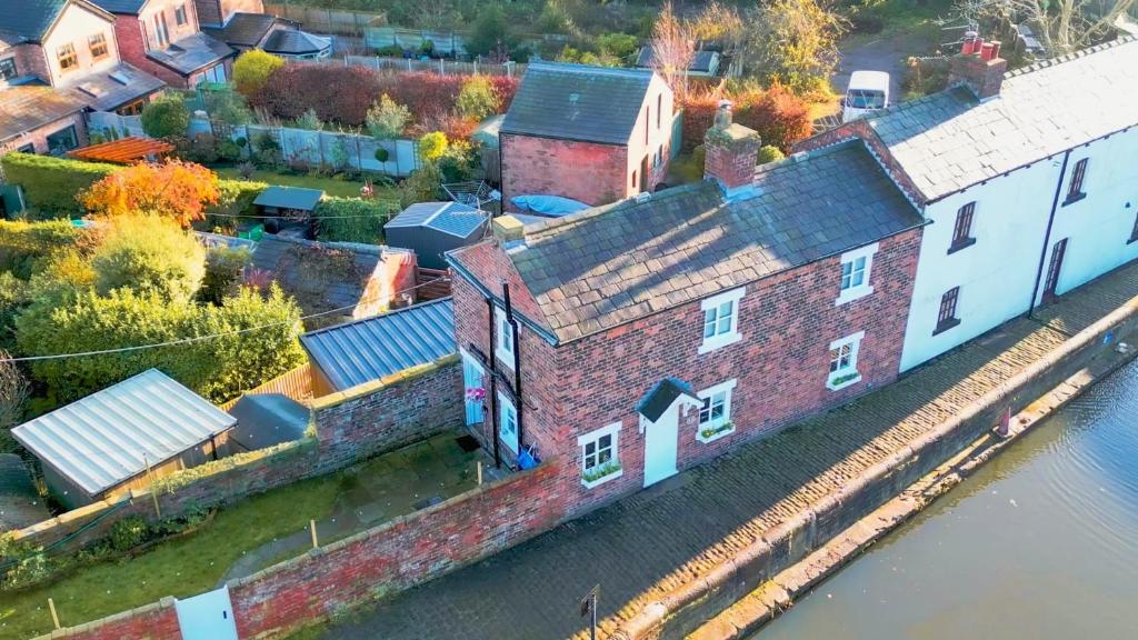 an aerial view of a building next to the water at 1 Top Locks Cottage in Burscough