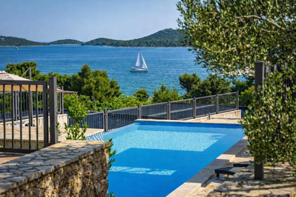 a swimming pool with a view of the water at Panorama Mobilehome Vista Kornati with Pool in Drage