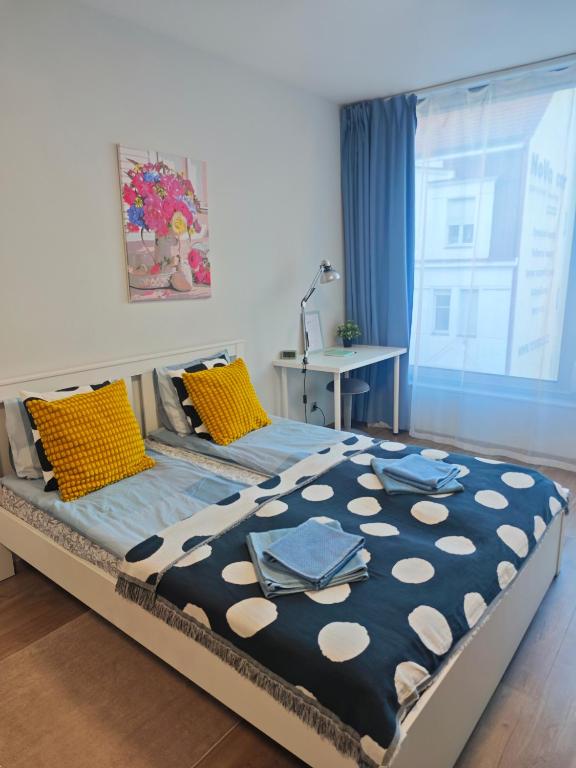 a bedroom with a large bed with yellow pillows at Comfort flat with great location in Prague