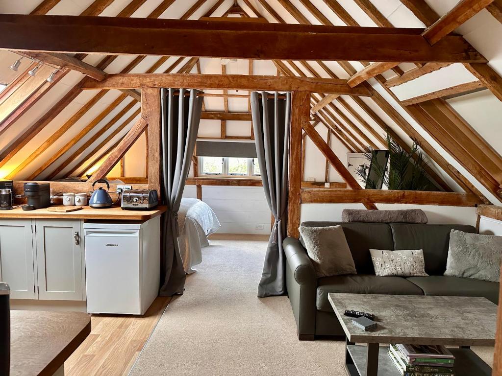 a living room with a couch and a table at The Granary in Hurstpierpoint