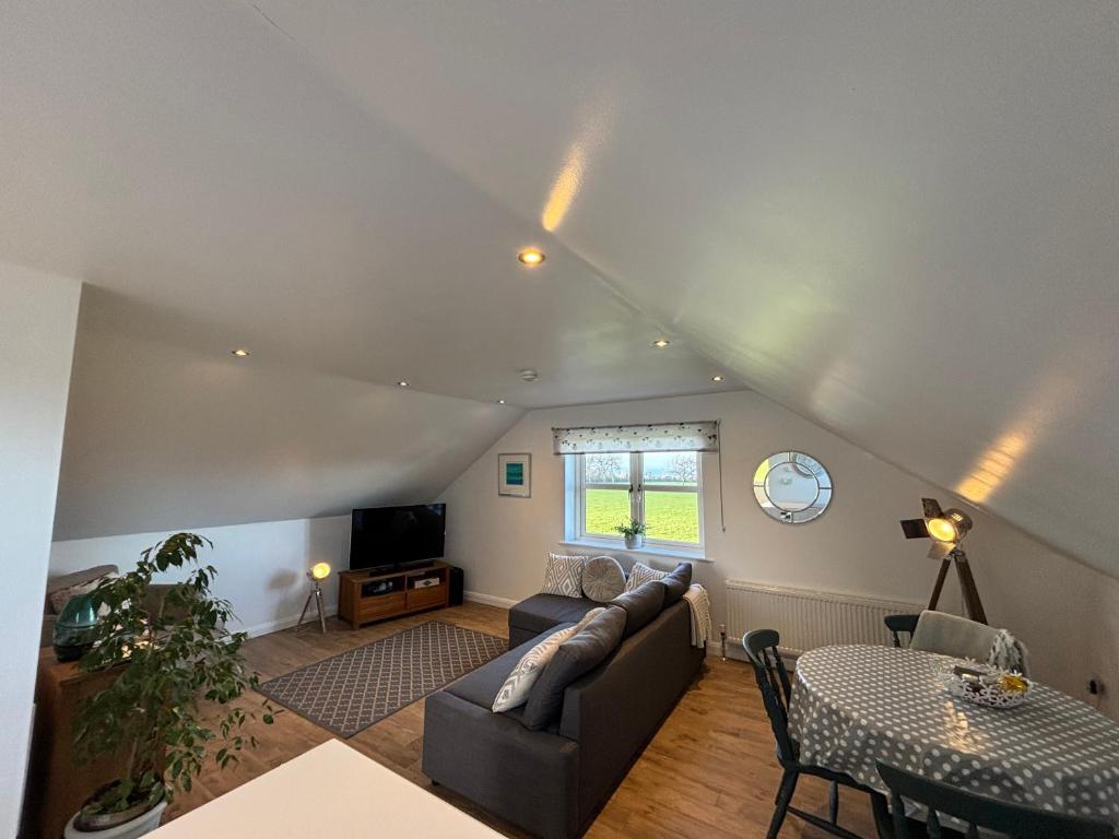 a living room with a couch and a table at Room with a View in Aldergrove