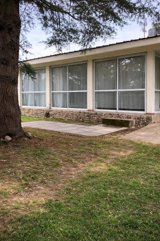 a house with a tree in front of it at El Bosque de Simba - Casa in La Estancia