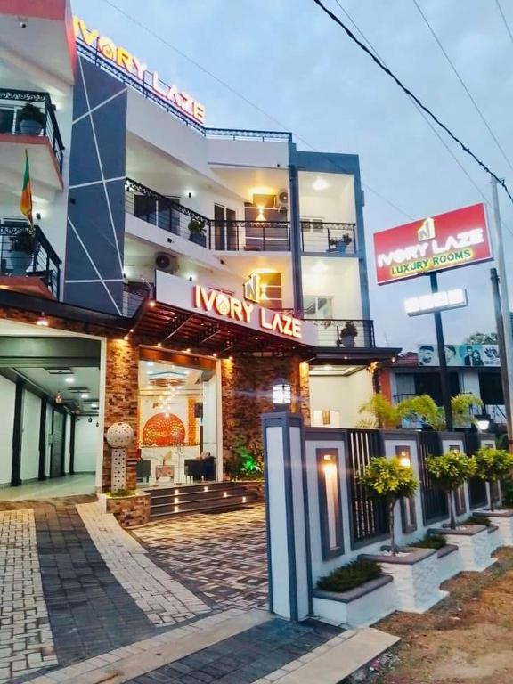 a building with a new lease sign in front of it at Ivory Laze Hotel in Negombo
